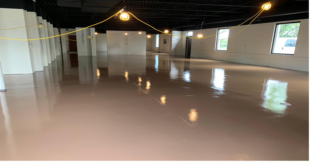 Large open floor coated in a warm neutral tone