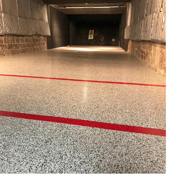 Flake epoxy floor inside an indoor shooting range